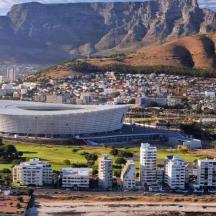 an aerial view of a soccer stadium in front of a mountain