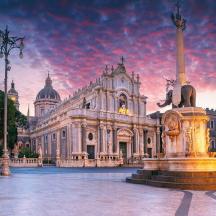 a large building with a fountain in front of it