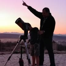 a man and a woman standing next to a camera