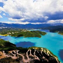 an aerial view of a lake in the mountains