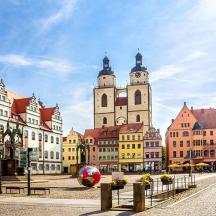 a group of buildings with two towers on a street