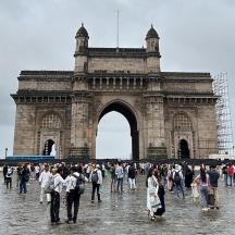 a group of people standing in front of an arch