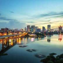 a city skyline with a bridge over a river