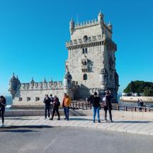 a group of people standing in front of a castle
