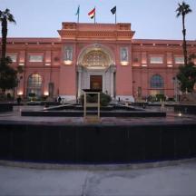 a large building with two statues in front of it