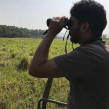 a man taking a picture of a field with a camera