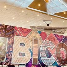 a large wall with a bq sign in a room