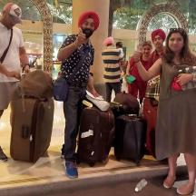 a group of people standing in an airport with luggage