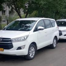 two white vehicles parked next to each other on a street
