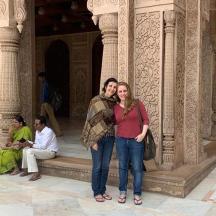 a man and woman standing in front of a building