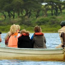 a group of people in a boat on the water
