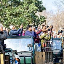 a group of people riding on the back of a truck