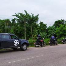 a group of motorcyclists are parked on the side of a road