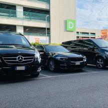 three cars parked in a parking lot in front of a building