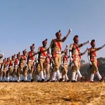 a group of men in uniform walking in a field