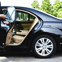 a man in a suit getting into a car