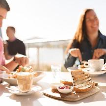 a group of people sitting at a table eating food