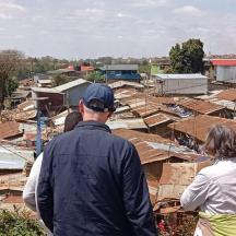 a group of people looking at roofs of houses
