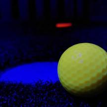bola golf hijau duduk di atas tanah