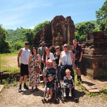 a group of people posing for a picture at a temple