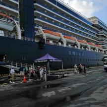 a cruise ship is docked next to a building