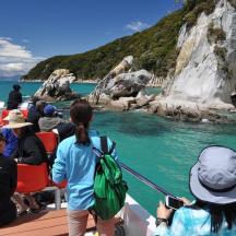 a group of people on a boat looking at the water