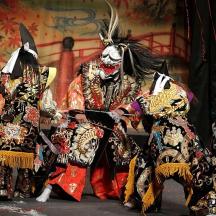 a group of people dressed in costumes on a stage