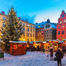 a christmas market in a city with a christmas tree
