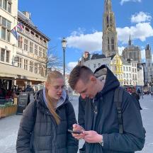 a man and a woman looking at a cell phone