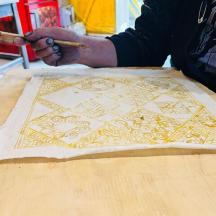 a person is cutting a piece of paper on a table