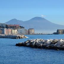 a group of rocks in the water with a city