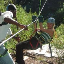 a woman on a zip line with a man