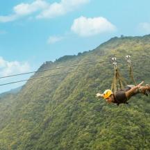 a person on a zip line in the mountains