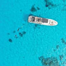 an aerial view of a boat in the ocean