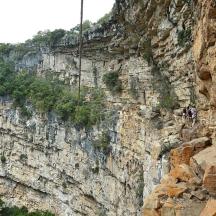 a person rappelling off of a mountain cliff