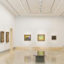 a gallery with many paintings on the walls