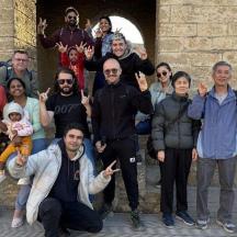 a group of people posing for a picture in front of a building