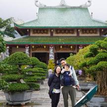 a man and a woman standing in front of a building