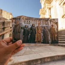 a hand holding a picture of a group of people
