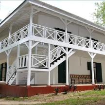a white house with a large white balcony