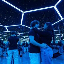 a group of people standing in a room with lights