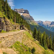 a road in the mountains with a car on the road