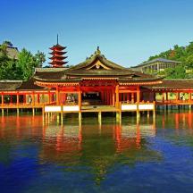 a building on a body of water with its reflection