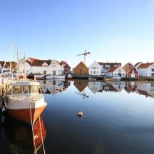 a boat is docked in the water next to houses
