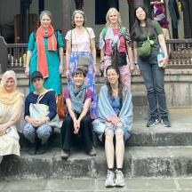 a group of women sitting on steps in front of a building