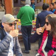 a man and a woman sitting down eating food