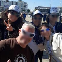 a group of people wearing hats and sunglasses