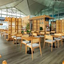 a dining room with wooden tables and chairs