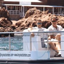 two men sitting on a boat in the water