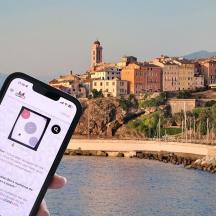 a person holding a cell phone in front of a river